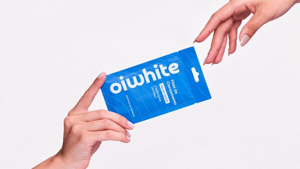 Oiwhite teeth whitening package held between two hands